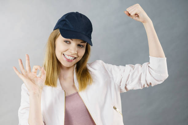 istock Young woman showing her arm muscles 830785980