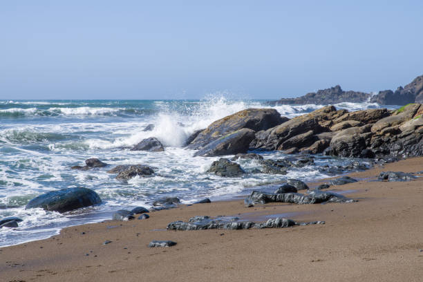 istock Surf and waves on a rocky coast 830815120