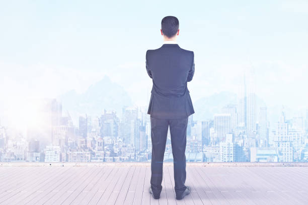 istock Businessman looking at city 830826714