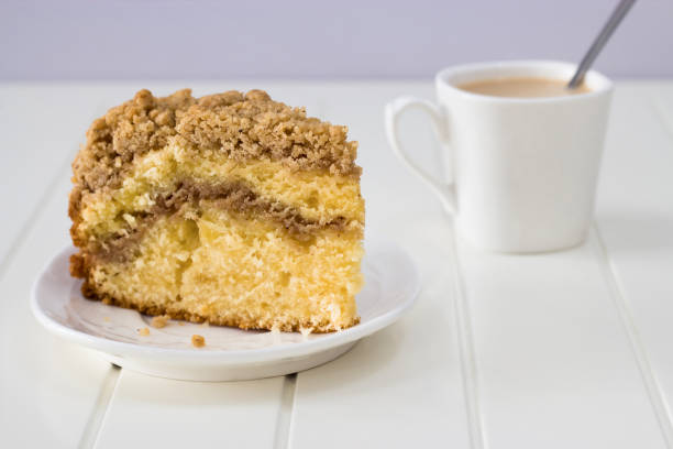 istock Cinnamon crumble coffee cake and cup of tea on white background 830828078