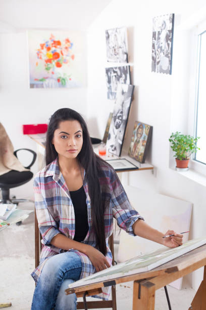 istock Female artist posing in art studio 830833622