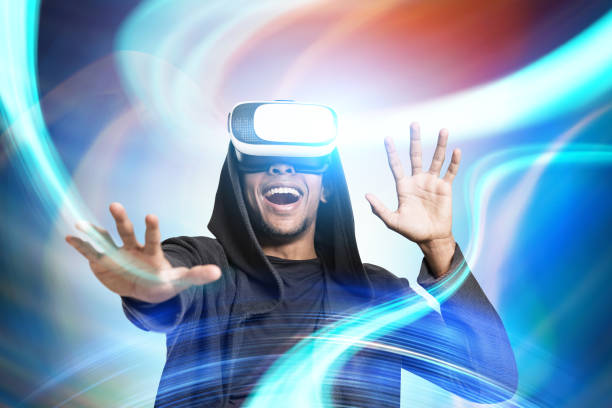 istock Smiling African guy in VR glasses, abstract 830834396