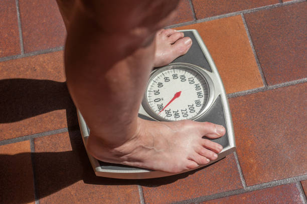 istock Overweight person on a bathroom scale 830840462
