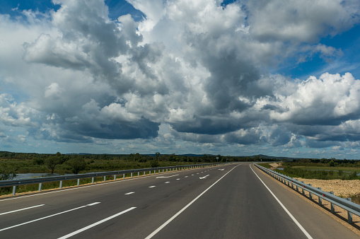 Beautiful sky with grey clouds above the highway in Russia