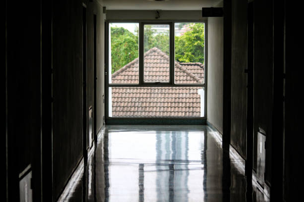 istock Window at the end of a dark hallway 830861906