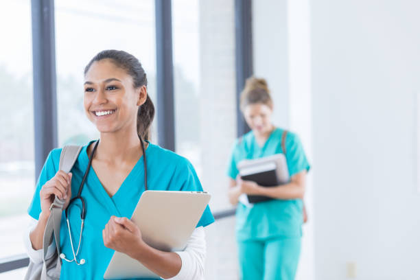 istock Beautiful mixed race nursing student walks in hospital hallway 830863226