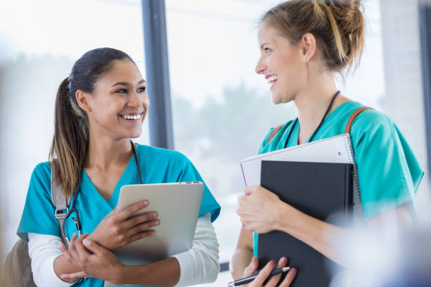 istock Nursing school friends talk in school hallway 830863300
