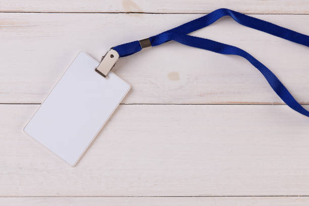 istock Blank Identification Card with Neckband on White Wooden Background 830873084
