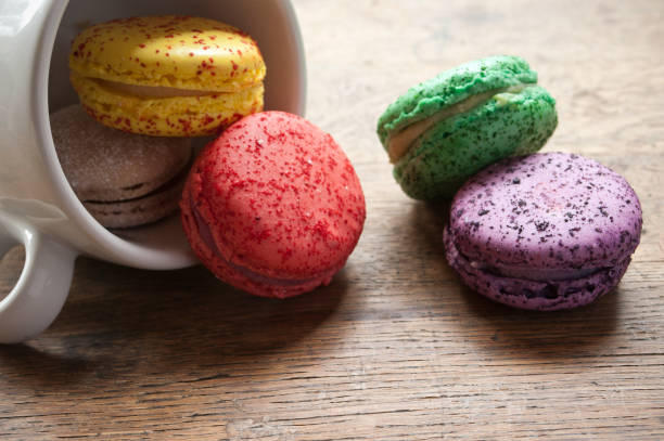 assortment of french macarons on wooden background assortment of french macarons on wooden background tasse café stock pictures, royalty-free photos & images