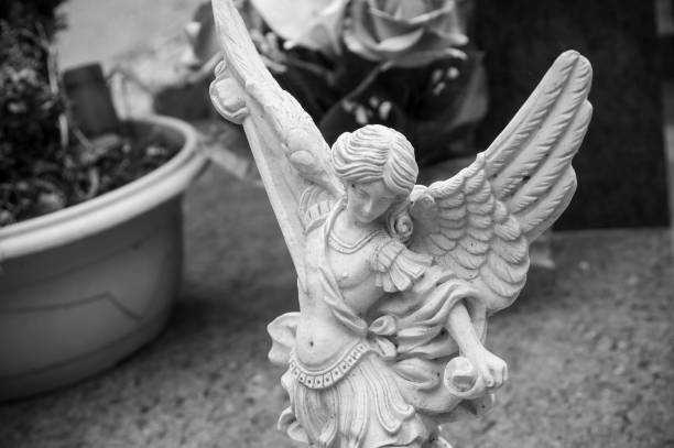 istock white angel in cemetery on a tomb 830971312