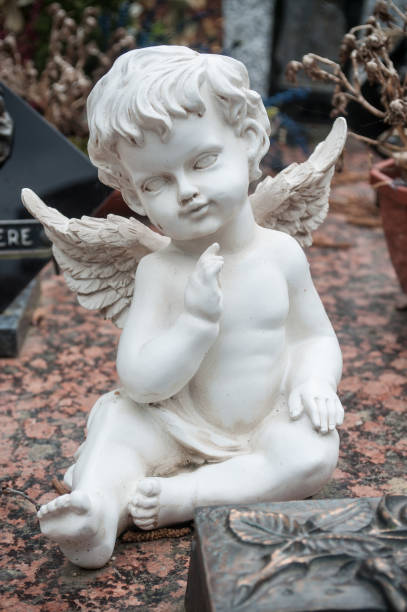 istock white angel in cemetery on a tomb 830971938