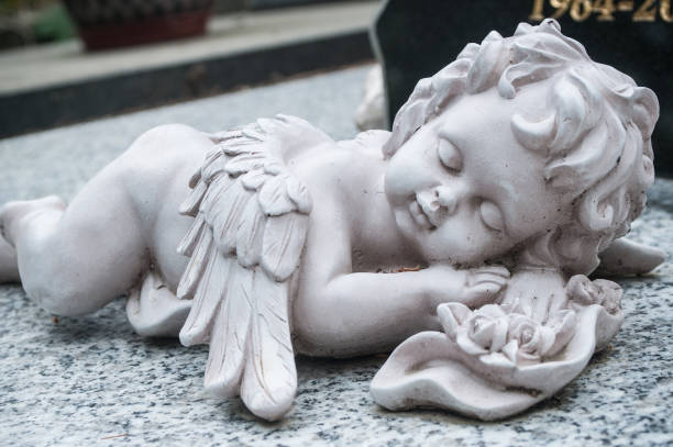 istock white angel in cemetery on a tomb 830972100