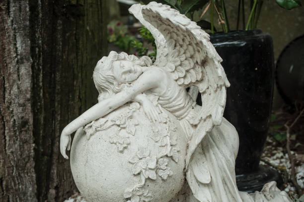 istock white angel in cemetery on a tomb 830972362