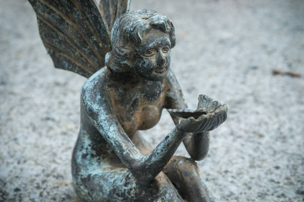 istock bronze angel in cemetery on a tomb 830975106