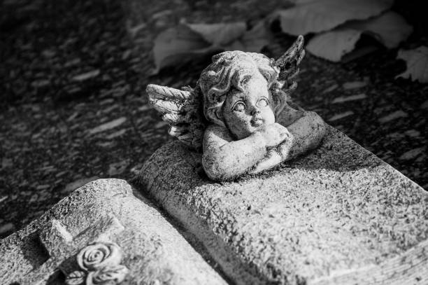 istock white angel in cemetery on a tomb 830975172