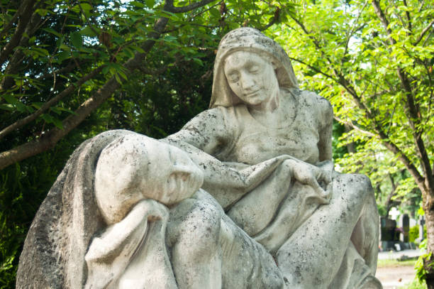 istock angel marble statue in cemetery 830976264