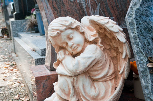 istock white angel in cemetery on a tomb 830976792
