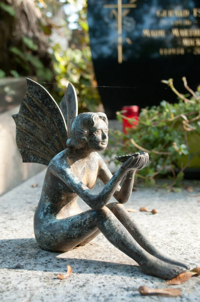 istock stoned angel in cemetery on a tomb 830976824