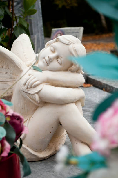 istock white angel in cemetery on a tomb 830976848