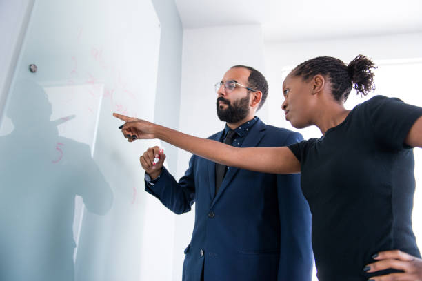 istock Businessman Writing on the Whiteboard 830979104