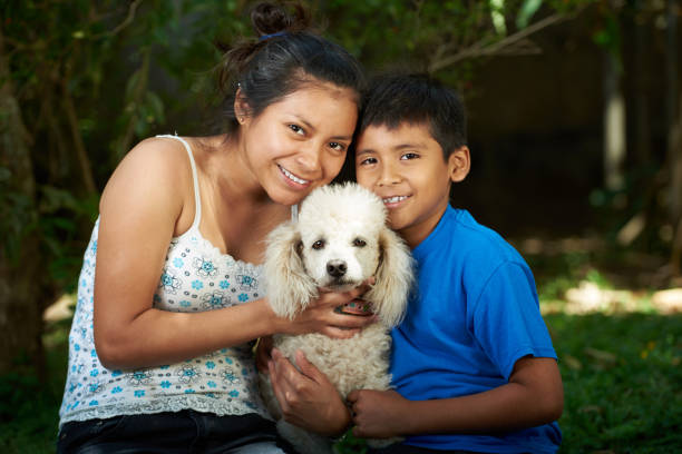 istock Boy and girl with poodle dog 830981206