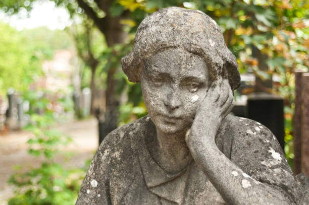 istock stoned angel  statue in cemetery 830981350