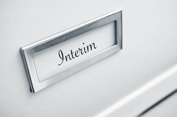 istock archive cardboard with sticker with word - interim 830981584