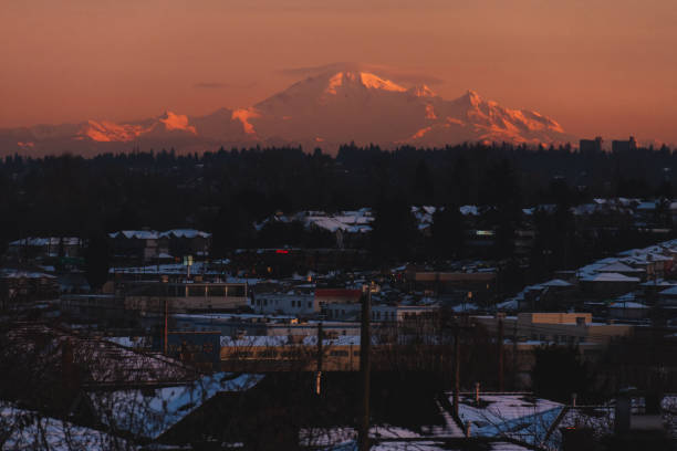 istock Mountains in snow with building in front while sunset or sunrise 830985724