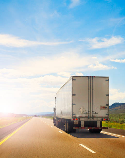 istock White Truck on a country road 830985928