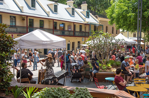 Sydney,NSW,Australia-November 20,2016: Crowds at The Rocks Centre food court area with musicians and local architecture in Sydney, Australia.