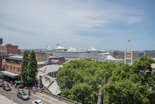 Sydney,NSW,Australia-November 20,2016: Elevated view over the overseas passenger terminal with cruise ship, clock tower and Glenmore Hotel restaurant crowds in Sydney, Australia.