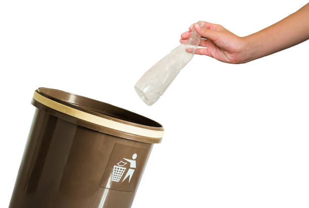 istock hand putting a bottle in recycling bin 830998402