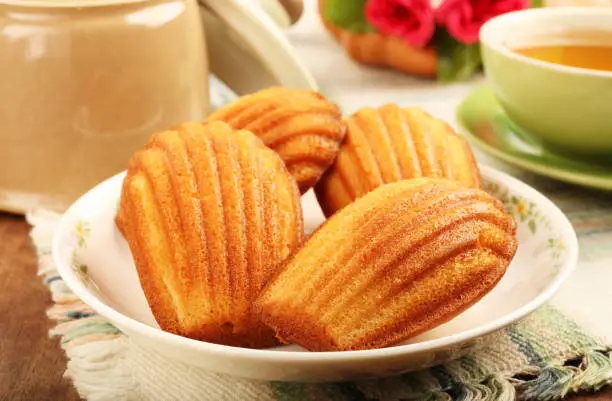 Madeleine cookie and cup of tea.