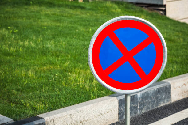 istock no parking sign at streetside 830999022