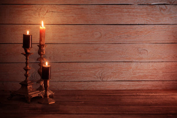 istock burning  candles in vintage  candlestick on wooden background 831006112