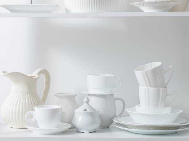 istock Clean dishes and vases on white wooden shelf 831006116