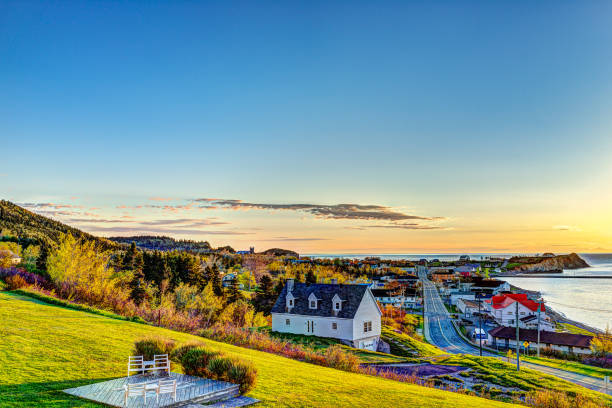 Hotel chairs on hill during sunrise in Perce, Gaspe Peninsula, Quebec, Canada, Gaspesie region with cityscape Hotel chairs on hill during sunrise in Perce, Gaspe Peninsula, Quebec, Canada, Gaspesie region with cityscape gaspe peninsula stock pictures, royalty-free photos & images