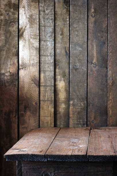 istock Empty wooden table against the wall of planks. 831011998