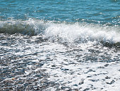 Wave splash on pebble beach