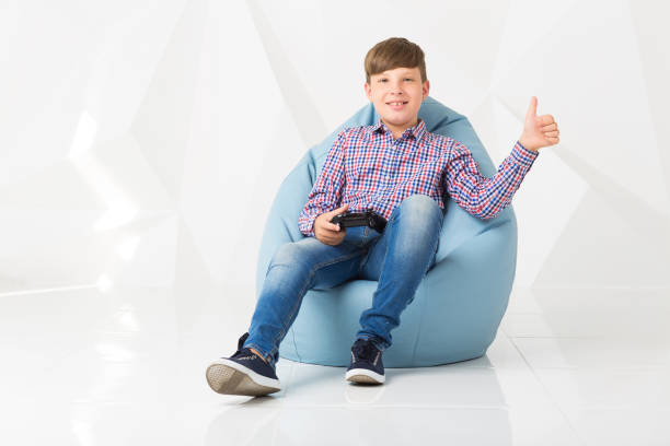 istock child hold gamepad in his hands. play video games 831013068