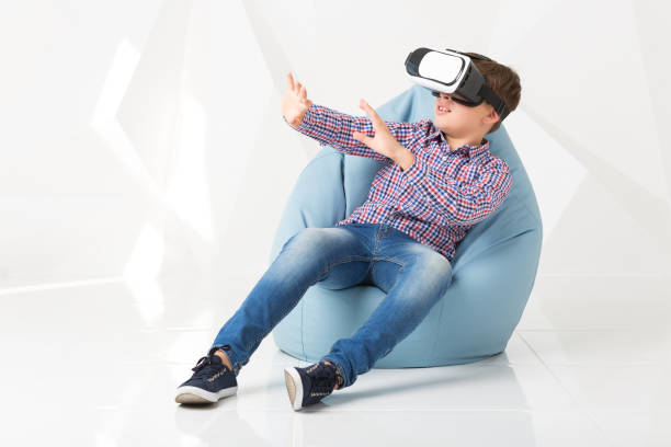 istock Emotional boy in virtual reality glasses on white background 831013150
