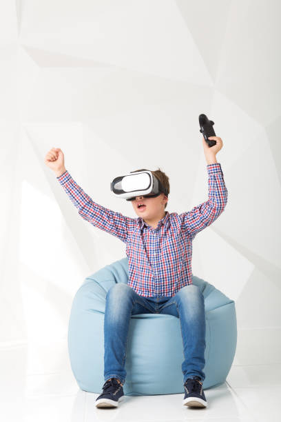 istock Emotional boy in virtual reality glasses on white background 831013190