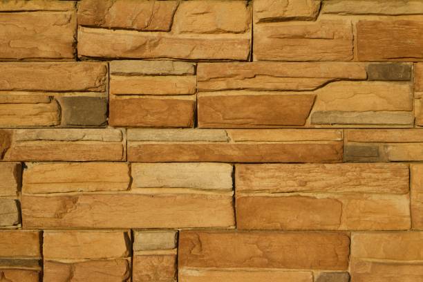 istock Golden Brown Limestone Brick Wall Background 831015598