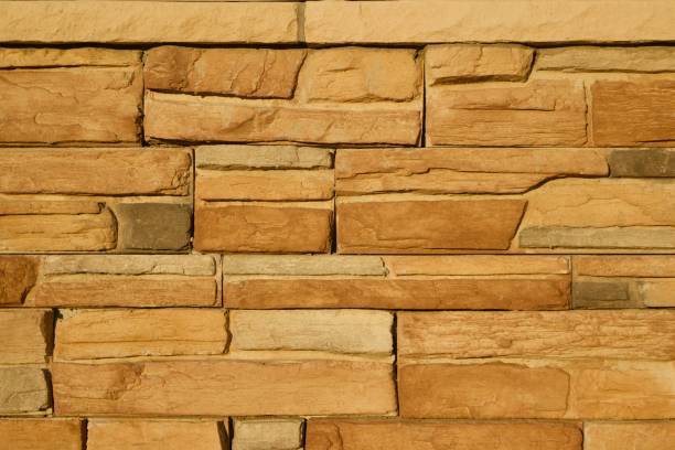 istock Golden Brown Limestone Brick Wall Background 831015696