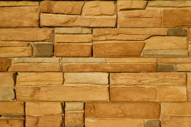 istock Golden Brown Limestone Brick Wall Background 831015740