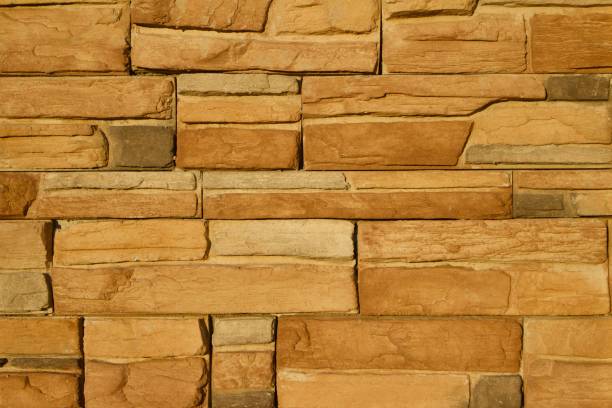istock Golden Brown Limestone Brick Wall Background 831015742