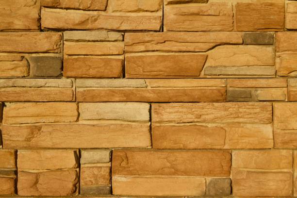 istock Golden Brown Limestone Brick Wall Background 831015976