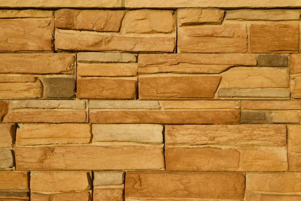 istock Golden Brown Limestone Brick Wall Background 831016180