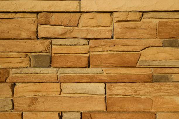 istock Golden Brown Limestone Brick Wall Background 831016188