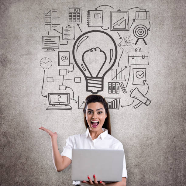 istock Ecstatic businesswoman holding laptop 831019404